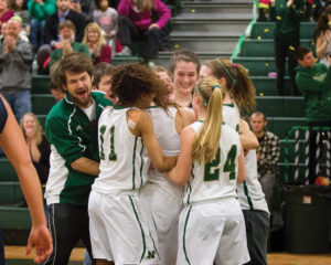 The undefeated girls basketball team is on their way to the Division 2 playoffs on Wednesday night. Pictured at right, they celebrate teammate Erin Cressman’s 1000th career point.  Susan Shaye; susanshaye.com