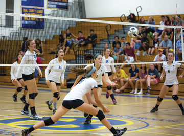 Nashoba at Acton-Boxborough. Above: Junior Meaghan McCarthy (#12) punches one over the net. Below, McCarthy with Jordan Bricknell (left) and Abigail Recko (#6, right).                                                              SusanShaye.com