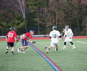 Nashoba’s Drew Korn (#19) and Hunter Boudreau (#22) on the field against North Middlesex                                               Adrian Flatgard;  frequentflyerphotographer@gmail.com