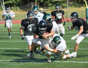 Nashoba defense takes down a Longmeadow player during last week’s scrimmage.  Stow’s Ben Hurley (#81) is seen at left. Nashoba’s season opener is at Westborough on Saturday, September 13.                    Adrian Flatgard; frequentflyerphotographer@gmail.com  