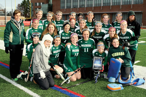 Before the start of Sunday’s game, the Nashoba Field Hockey team was presented with the MIAA Sportsmanship Award.  They were selected by the MIAA Field Hockey Committee. The team i spictured above with their award. Below: Stow senior captain #5 Emma Caviness up against #7 Leah Cardarelli from Acton-Boxborough.                                           Susan Shaye; www.susanshaye.com