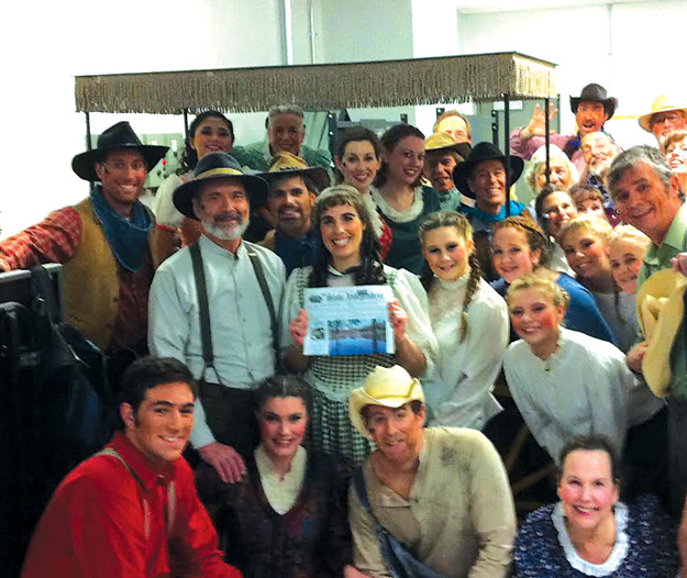 Debbie Crane (holding the paper ) with many of her cast mates from The Savoyard Light Opera Company’s production of Rodger and Hammersteins Oklahoma in Carlisle.  