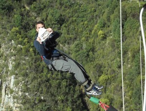 Frank Smith tries to read after leaping from Bloukrans Bridge on the border of the Eastern and Western Cape, during a road trip across the southern coast of South Africa. The jump is run by Face Adrenalin, and is the third highest commercial bungee jump in the world, at 216 metres.  