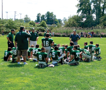 The 5th/6th grade Nashoba Youth Football team during halftime at Saturday’s. jamboree. Head coach Mike Guthrie speaks to the team.            Michael LeClair
