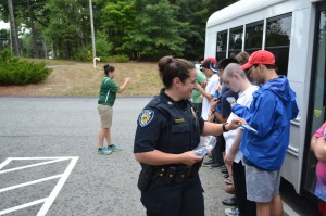 Stow Police Officer Cassandra Ela gifts each student with their own Stow Police patch.  Ann Needle photo