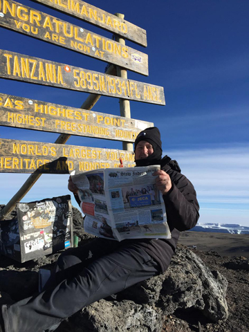 Robert Bell, recently featured in an article about his journey to the top of Mt. Kilimanjaro, is seen here at the summit, elevation 19,341 feet. Kilimanjaro is the highest mountain in Africa and the highest free-standing mountain in the world.  Thanks to Mr. Bell for taking us to the top to reach new heights! 